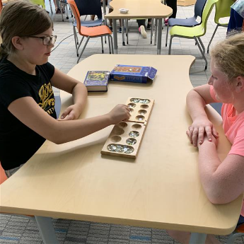 Students play mancala during Wednesday rotations.